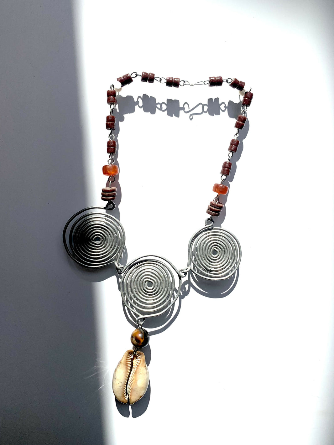 Sankofa crest with big cowrie